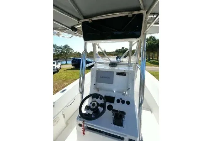 Slide: The Image of 1999 Contender 28 Sport boat console with steering wheel and navigation equipment. - 4