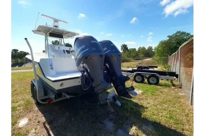 Slide: The Image of 1999 Contender 28 Sport boat with dual Yamaha outboard motors on a trailer. - 17