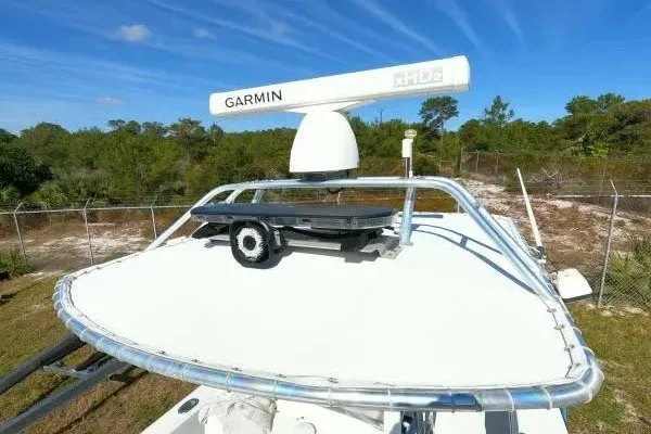 Slide: The Image of 1999 Contender 28 Sport boat with Garmin radar on top, clear blue sky background. - 5