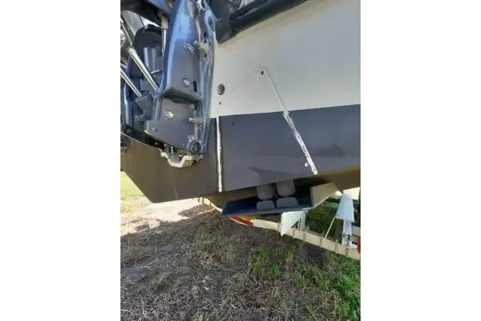 Slide: The Image of 1999 Contender 28 Sport boat hull and engine detail on trailer. - 7