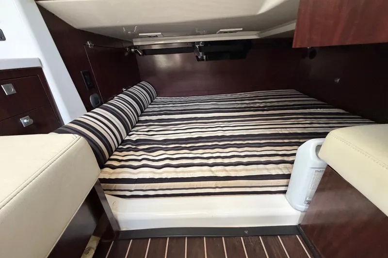 Slide: The Image of Interior cabin of 2018 Monterey 378SE Super Express with striped bedding. - 18