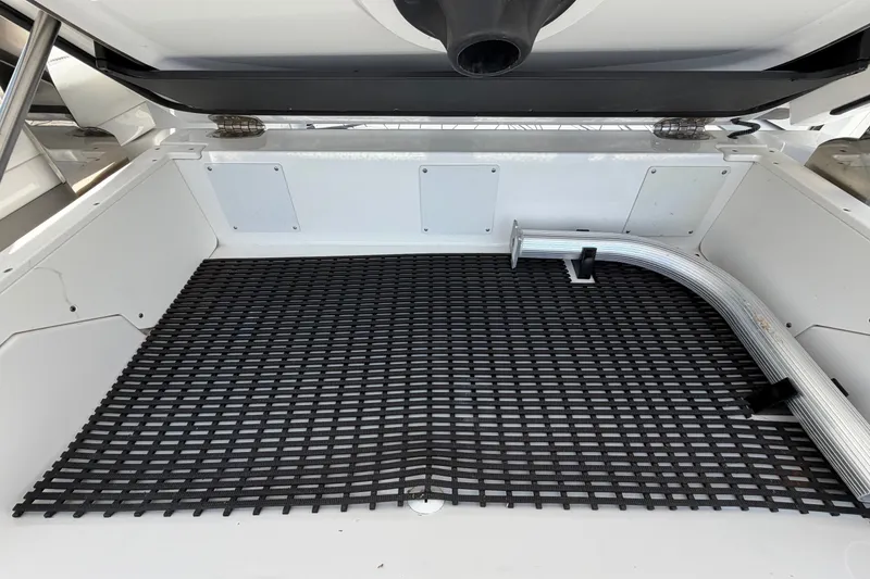 Slide: The Image of Interior of a 2018 Monterey 378SE Super Express boat with black grid mat and metal pipe. - 13