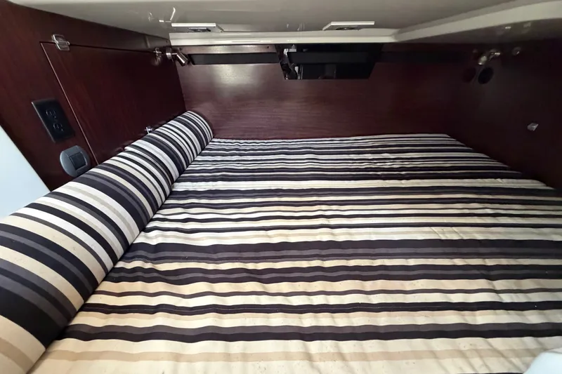 Slide: The Image of Cozy cabin interior with striped bedding in 2018 Monterey 378SE Super Express boat. - 17