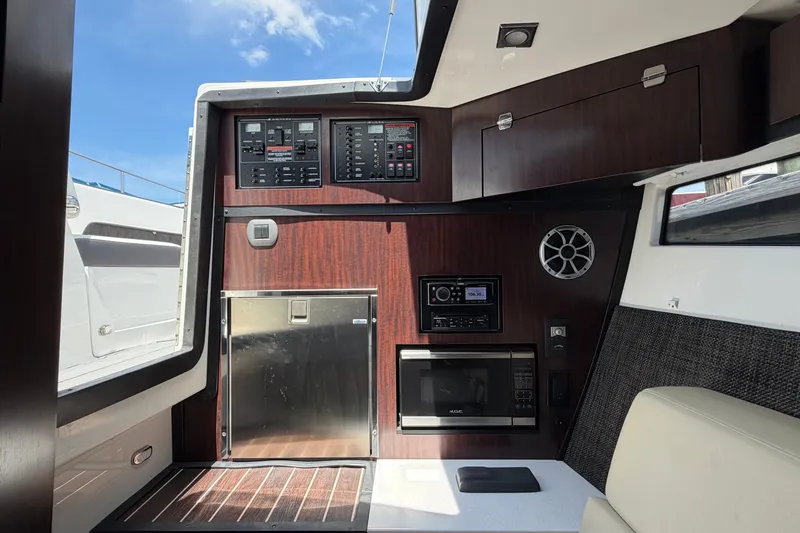 Slide: The Image of Interior of 2018 Monterey 378SE Super Express boat with control panels and appliances. - 21