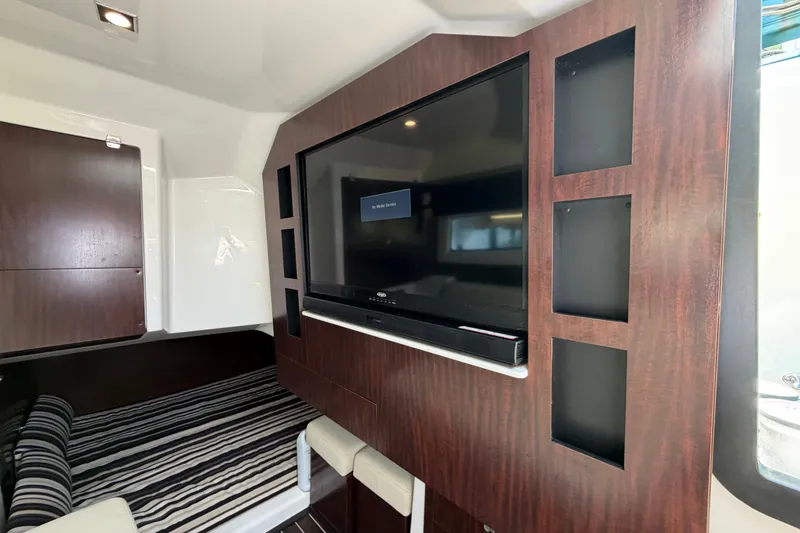 Slide: The Image of Interior of 2018 Monterey 378SE Super Express with TV and striped bedding. - 19