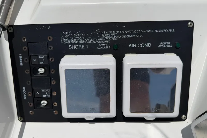 Slide: The Image of Control panel of a 2018 Monterey 378SE Super Express boat, featuring shore power and air conditioning switches. - 16
