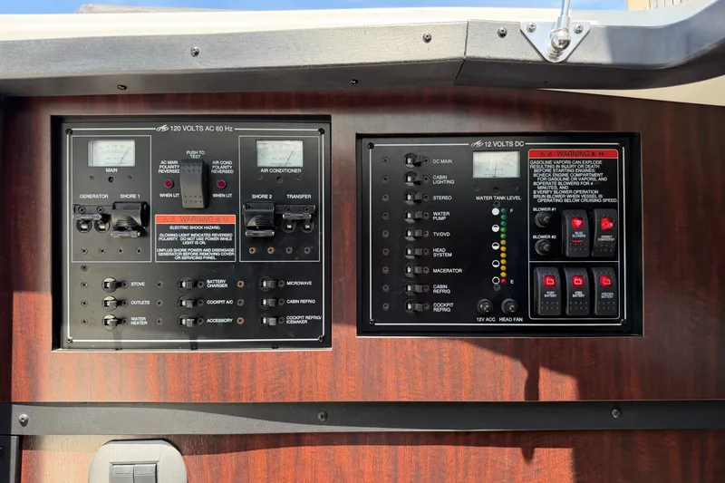 Slide: The Image of Control panel of a 2018 Monterey 378SE Super Express boat, featuring various switches and gauges. - 27