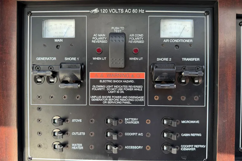 Slide: The Image of Electrical control panel of a 2018 Monterey 378SE Super Express boat, featuring switches and warning labels. - 29