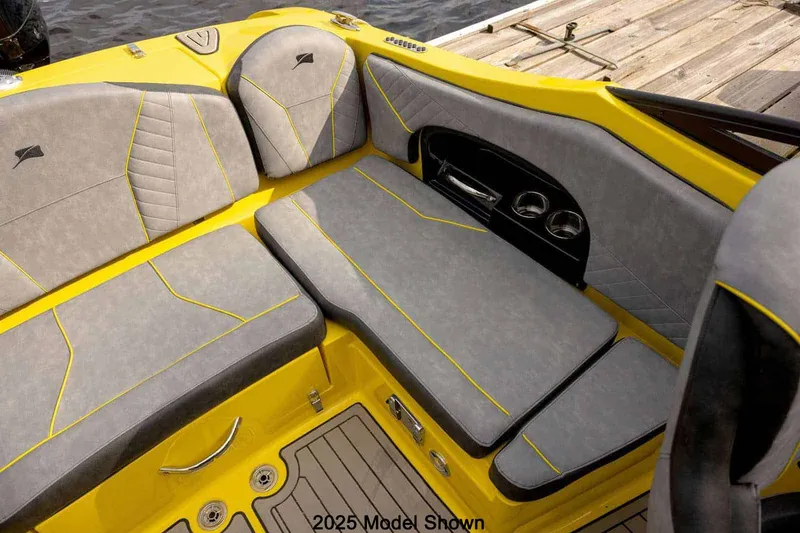 Slide: The Image of The image shows the cockpit of a Stingray 23 OCX boat with gray and yellow upholstery. - 4