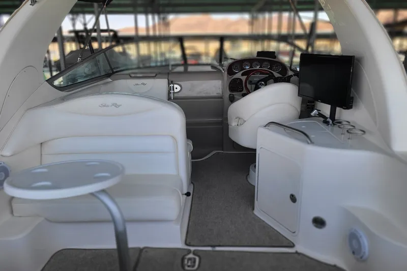 Slide: The Image of 2004 Sea Ray Sundancer 280 interior with helm, seating, and entertainment system. - 13