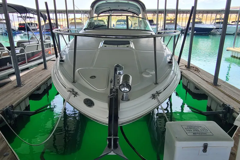 The Image of 2004 Sea Ray Sundancer 280 docked in a marina with vibrant green water. - 19