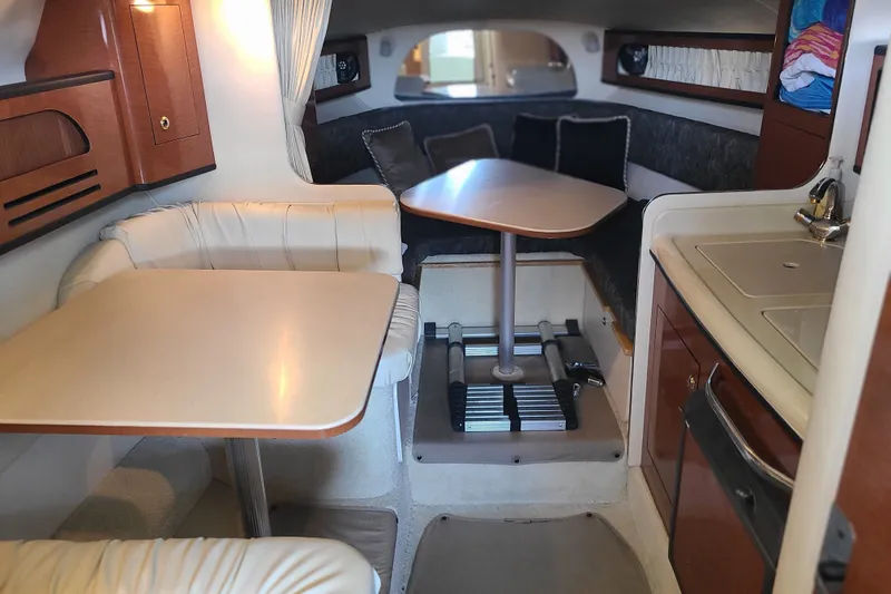 Slide: The Image of Interior of 2004 Sea Ray Sundancer 280, featuring dining area and kitchenette. - 6
