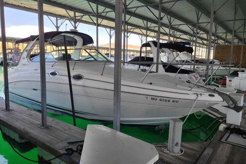 The Image of 2004 Sea Ray Sundancer 280 docked in a covered marina. - 2