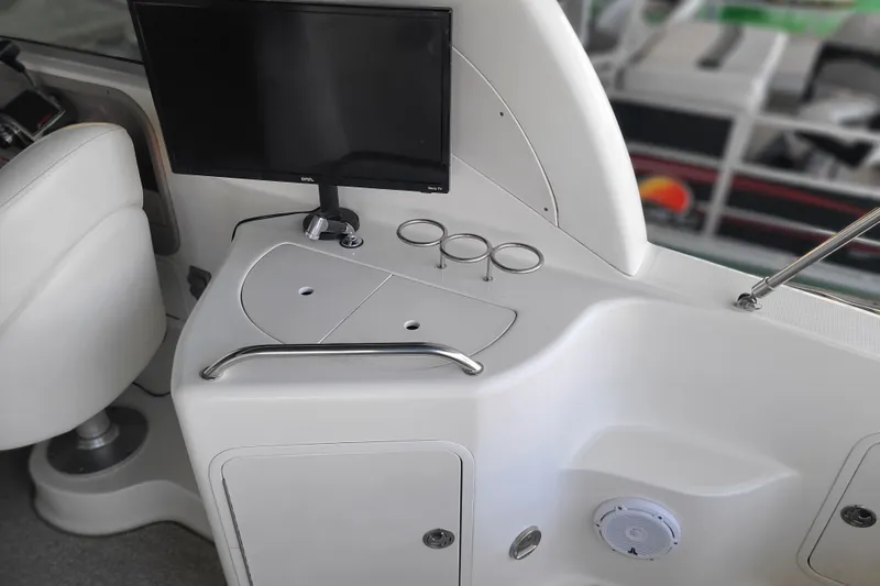 Slide: The Image of Interior of a 2004 Sea Ray Sundancer 280 boat with a monitor and cup holders. - 11