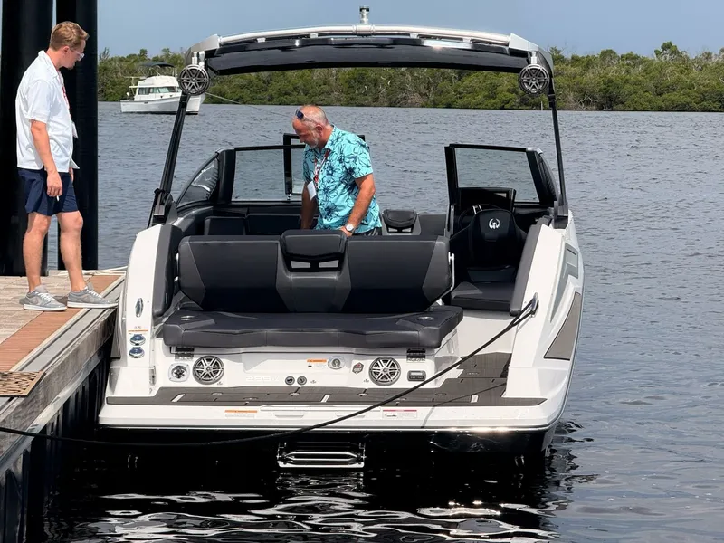 Slide: The Image of A modern 2026 Scarab 285 LX is docked. Two people are on board. - 4