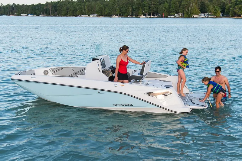 Slide: The Image of A family enjoys a day on a white Scarab 195 Open ID boat on a calm lake. - 9