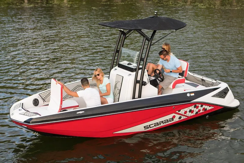 The Image of A red 2019 Scarab 195 Open ID boat on the water with four people on board. - 7