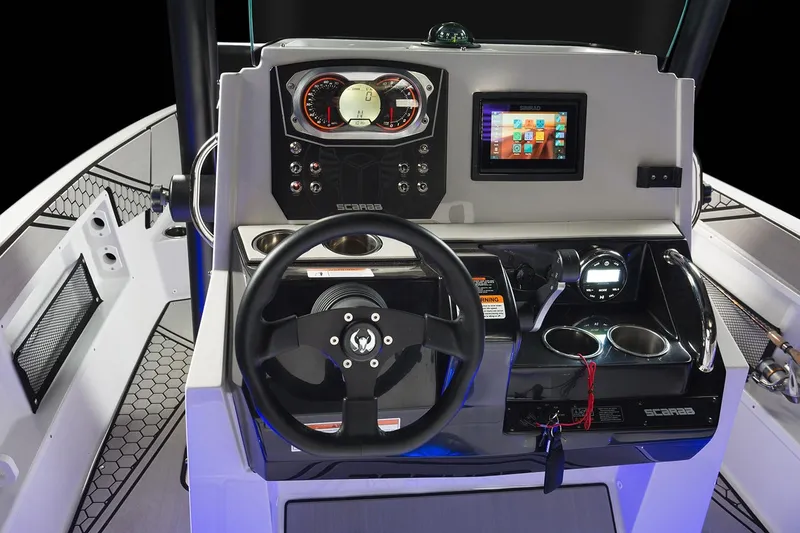 Slide: The Image of The image shows the cockpit of a 2019 Scarab 195 Open ID boat with modern instruments. - 17