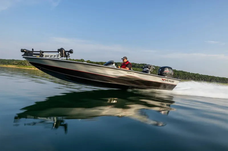 Slide: The Image of A 2024 Vexus AVX1880 boat speeds across calm water under a clear blue sky. - 18