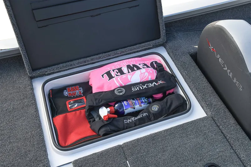 Slide: The Image of An open storage compartment in a Vexus AVX1880 boat shows various items, including clothing and accessories. - 13