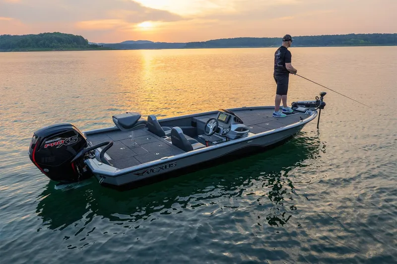 Slide: The Image of An angler stands on a Vexus AVX1880 boat on a calm lake at sunset. - 19