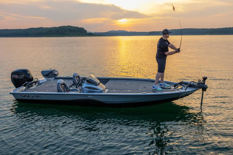 Slide: The Image of An angler stands on a Vexus AVX1880 boat, casting a line. The sunset reflects on the water. - 16