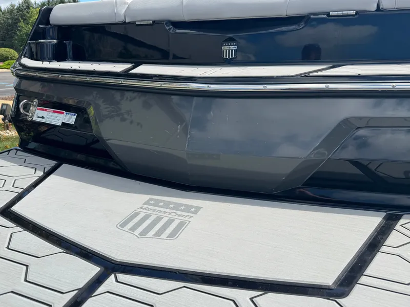 Slide: The Image of The image shows the rear of a 2020 MasterCraft NXT20 boat with a gray platform. - 6