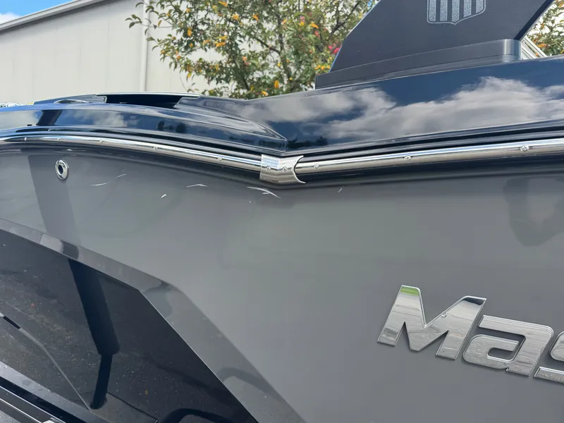 Slide: The Image of Close-up of the rear of a 2020 MasterCraft NXT20 with shiny chrome details. - 7