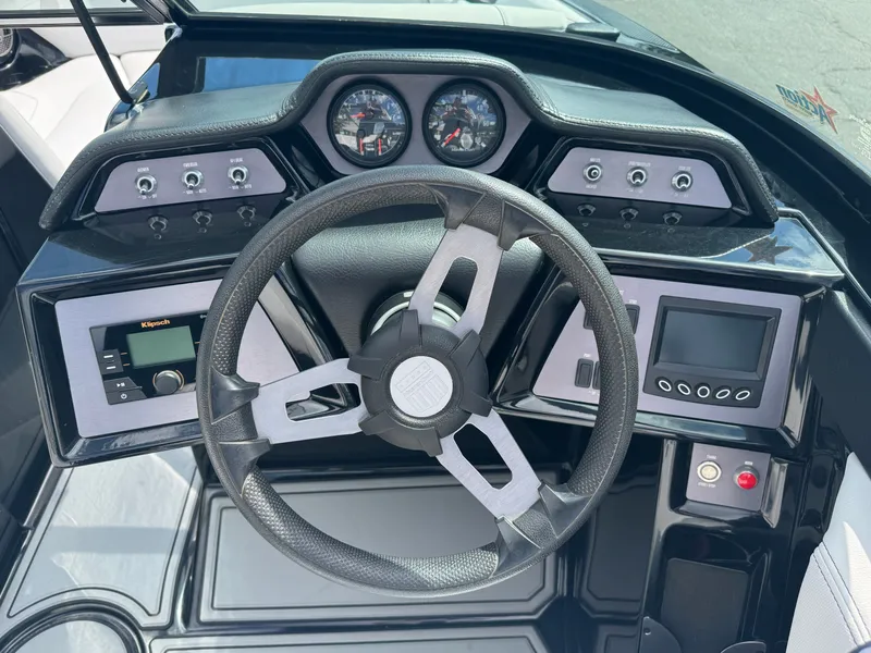 Slide: The Image of The image shows the dashboard of a 2020 MasterCraft NXT20 with a steering wheel and instruments. - 13