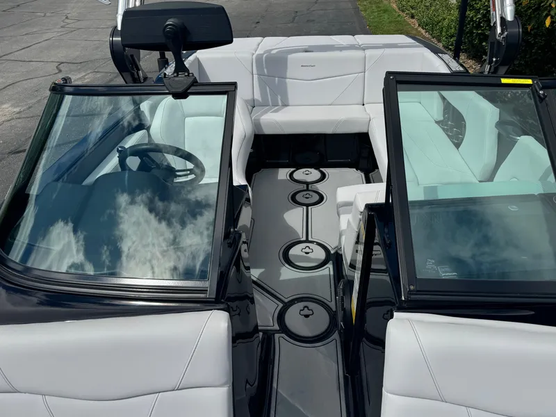 Slide: The Image of The image shows the cockpit of a 2020 MasterCraft NXT20 with white upholstery and glass windows. - 17