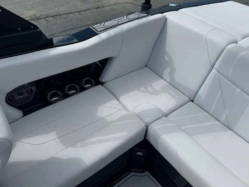 Slide: The Image of The 2020 MasterCraft NXT20 features luxurious white upholstery with built-in cup holders. - 11