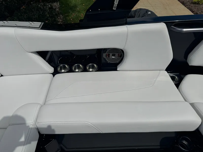Slide: The Image of The 2020 MasterCraft NXT20 features luxurious white upholstery with cup holders. - 15