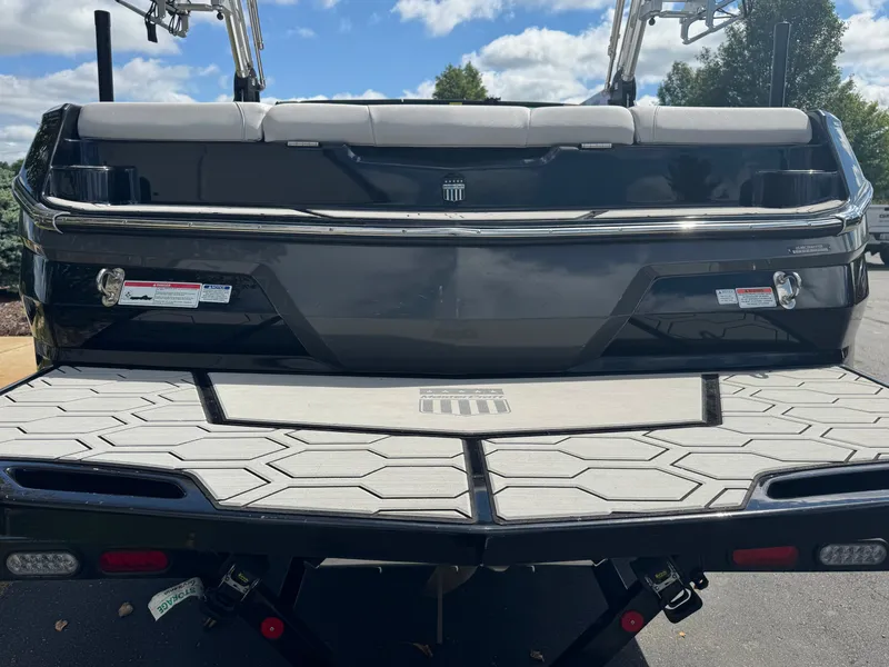 Slide: The Image of The image shows the rear of a 2020 MasterCraft NXT20 boat with gray upholstery. - 5