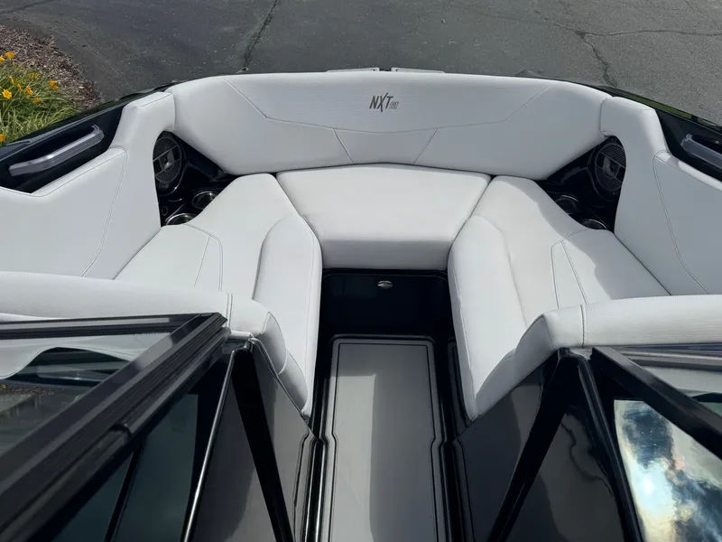 Slide: The Image of The image shows the bow area of a 2020 MasterCraft NXT20 with white upholstery. - 16