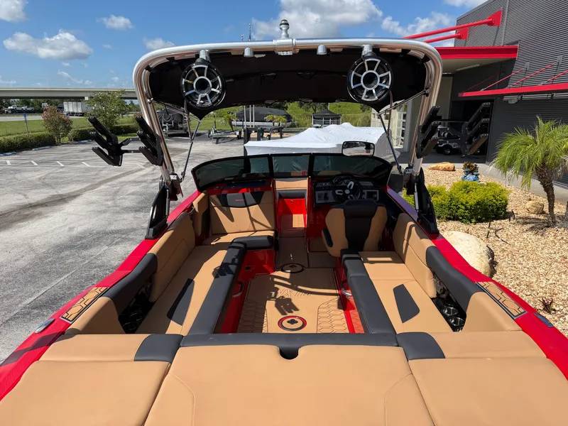 Slide: The Image of The image shows the interior of a 2022 MasterCraft NXT24 boat with red and beige seating. - 8