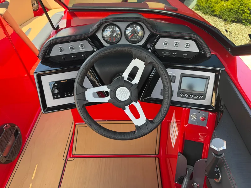 Slide: The Image of The image shows the cockpit of a 2022 MasterCraft NXT24 with a modern dashboard and steering wheel. - 15