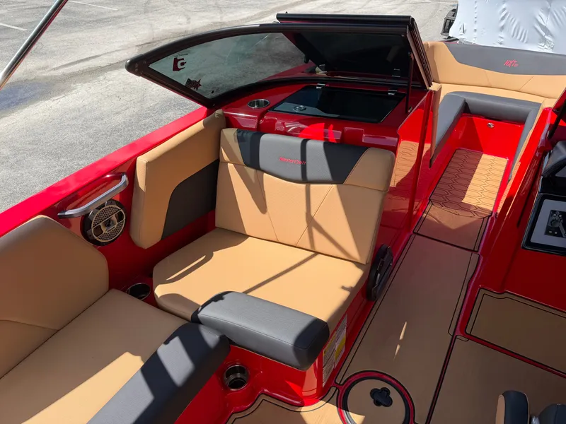 Slide: The Image of The image shows the interior of a 2022 MasterCraft NXT24 boat with red and beige seating. - 13