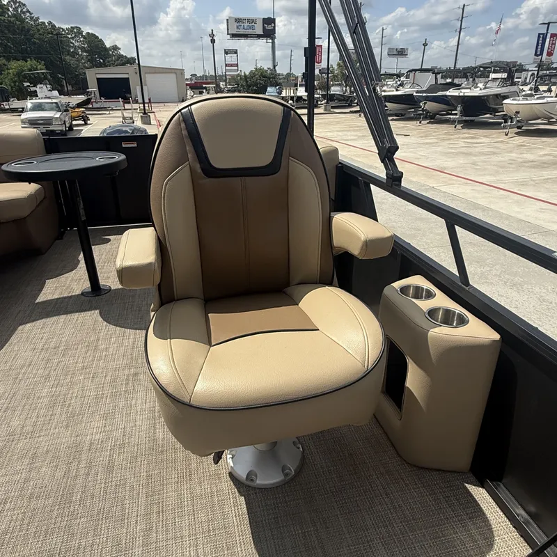 Slide: The Image of A luxurious swivel captain's chair in a Viaggio L20U boat, surrounded by cup holders and a table. - 15