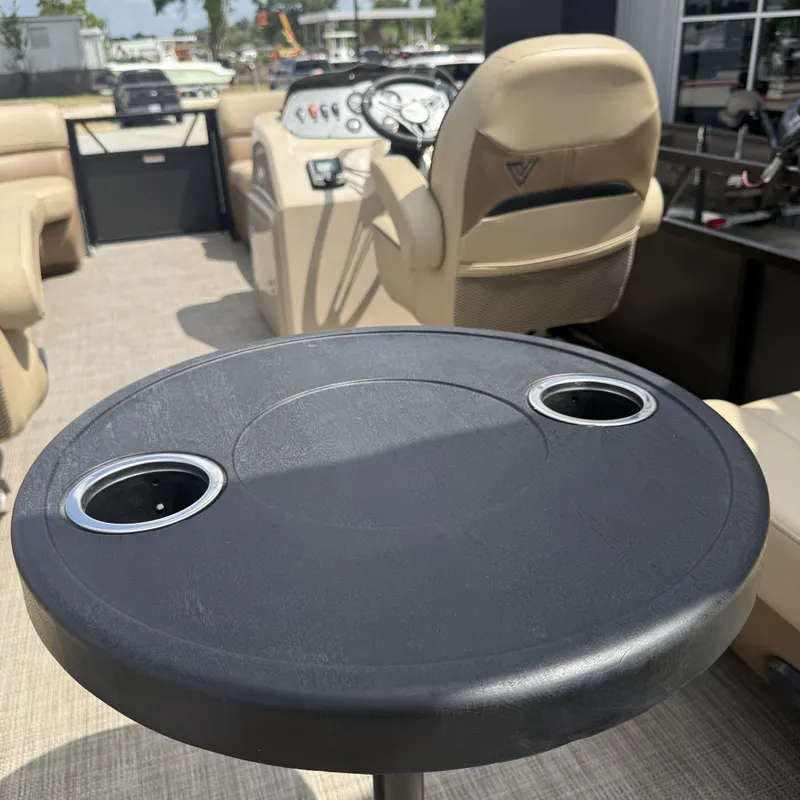 Slide: The Image of A 2022 Viaggio L20U pontoon boat with a table featuring cup holders and beige seating. - 22