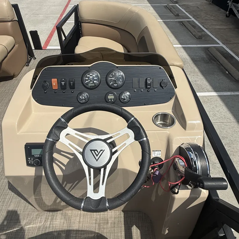 Slide: The Image of The image shows the helm of a 2022 Viaggio L20U boat with a steering wheel and instruments. - 17
