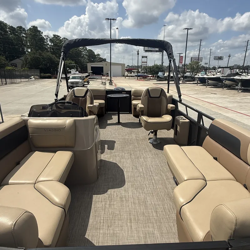 Slide: The Image of The image shows the interior of a 2022 Viaggio L20U pontoon boat with beige seating. - 13