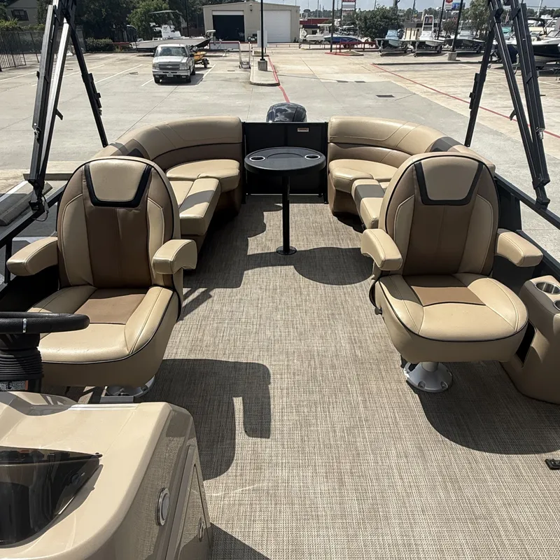 Slide: The Image of The image shows the spacious deck of a 2022 Viaggio L20U pontoon boat with beige seating. - 14
