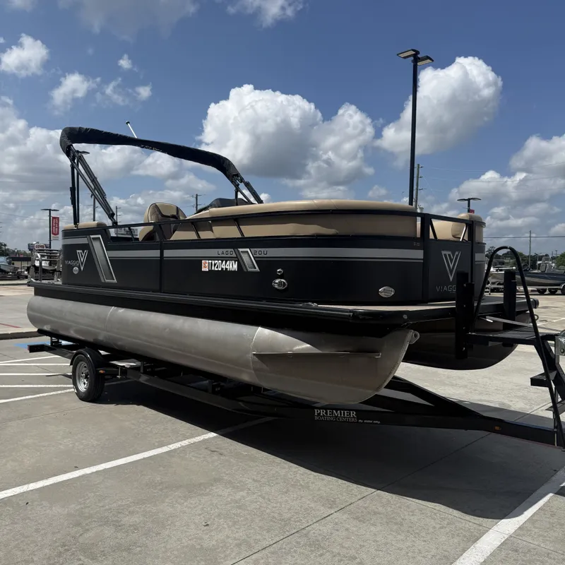 Slide: The Image of A 2022 Viaggio L20U pontoon boat on a trailer, featuring a black hull and beige canopy. - 6
