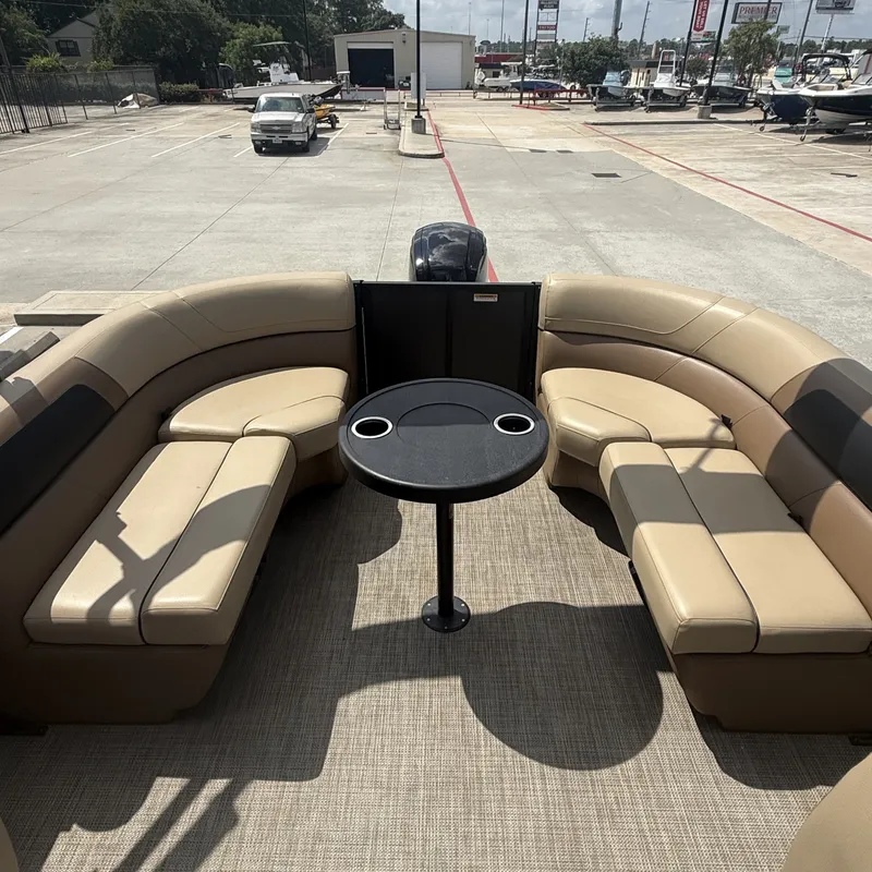 Slide: The Image of The image shows the deck of a 2022 Viaggio L20U pontoon boat with beige seating and a table. - 19