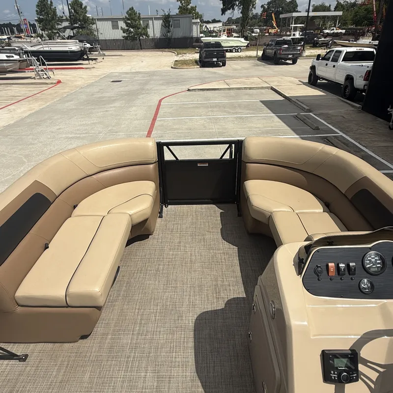 Slide: The Image of The image shows the interior of a 2022 Viaggio L20U pontoon boat with beige seating. - 24