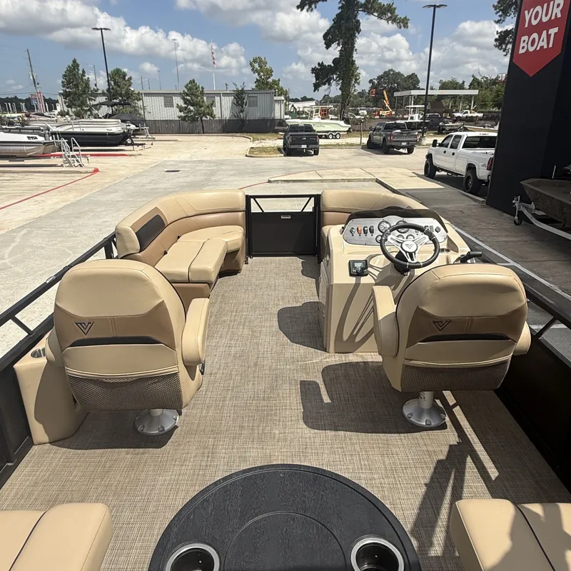 Slide: The Image of The image shows the interior of a 2022 Viaggio L20U pontoon boat with beige seating. - 23