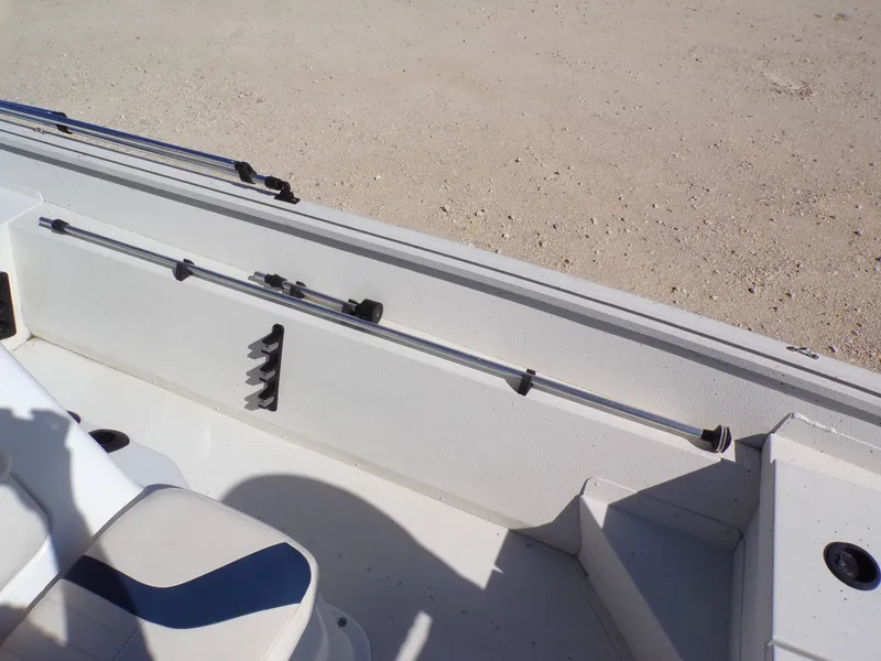 Slide: The Image of The image shows the interior of a 2018 G3 Bay 18 boat with seating and fishing rod holders. - 22
