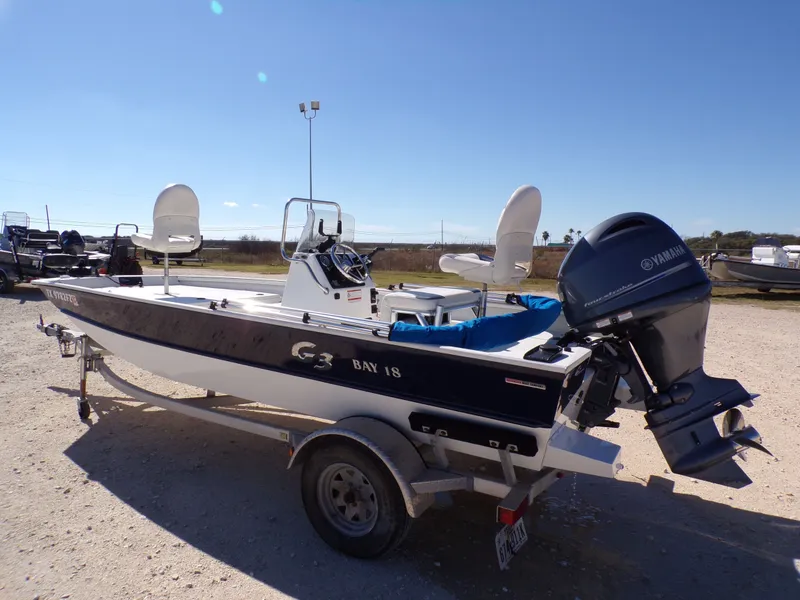 Slide: The Image of A 2018 G3 Bay 18 boat on a trailer, equipped with a Yamaha outboard motor. - 14