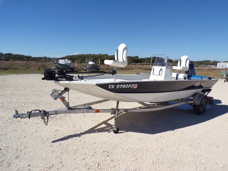 Slide: The Image of A 2018 G3 Bay 18 boat on a trailer in a gravel lot. - 9