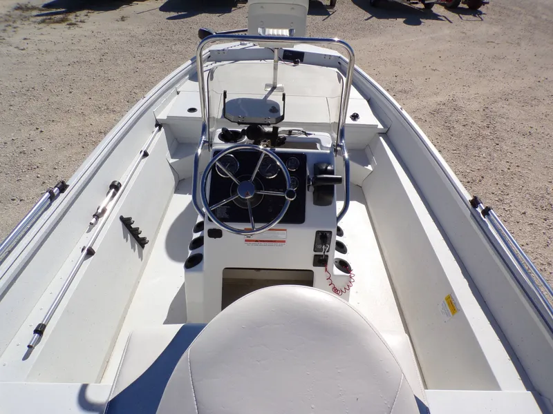 Slide: The Image of The image shows the cockpit of a 2018 G3 Bay 18 boat with a central helm. - 7